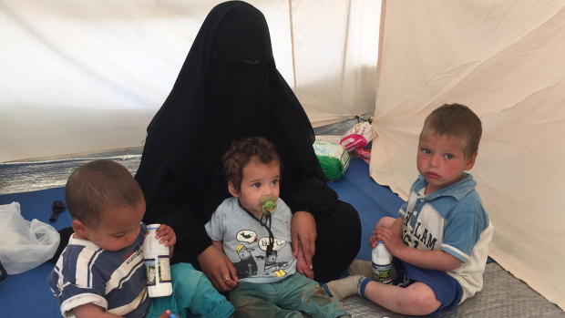 Australian woman Shayma Assaad, 19, and her three sons in her tent at the al-Hawl camp in north-eastern Syria. She is the wife of Mohammed Noor Masri, another Australian who went to live with Islamic State and is now detained separately from his wife.