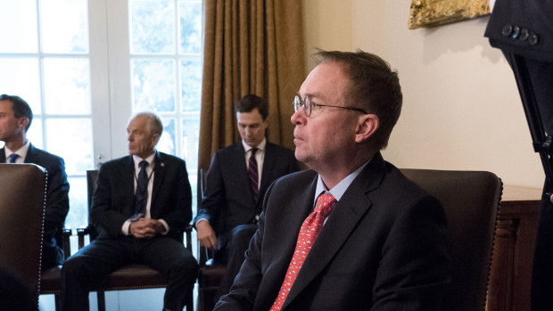 Mick Mulvaney, the acting White House Chief of Staff and direc­tor of the Offic­e of Manag­ement and Budge­t, looks on as President Donald Trump speaks during a meeting in the Cabinet Room of the White House in Washington in January.