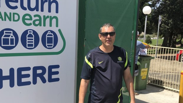 Emmanuel Zammit sifts through recycling bins for drink containers to cash in at the reverse vending machine in Bondi.