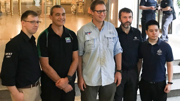 Craig Challen (second from left), Dr Richard Harris (centre) with DFAT staff at his hotel on Wednesday. 