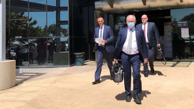 John Osborne from Ardent Leisure (left) and Bruce Hodgkinson, QC, wearing a mask, leave Southport Magistrates Court.