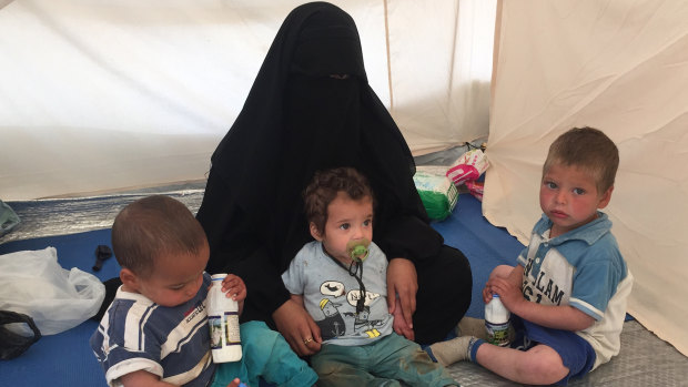 Australian woman Shayma Assaad, 19, and her three sons in her tent at the al-Hawl camp in north-eastern Syria. She is the wife of Mohammed Noor Masri, another Australian who went to live with Islamic State and is now detained separately from his wife.