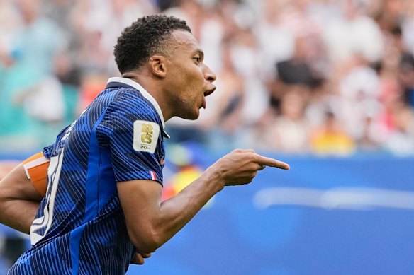 Kylian Mbappe celebrates his team's third goal against England.