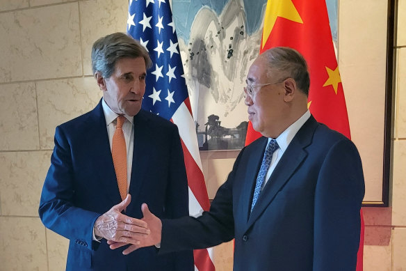 US envoy John Kerry shakes hands with his Chinese counterpart Xie Zhenhua before a meeting in Beijing on Monday.