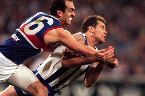 Wayne Carey and Matthew Croft fight for the ball.