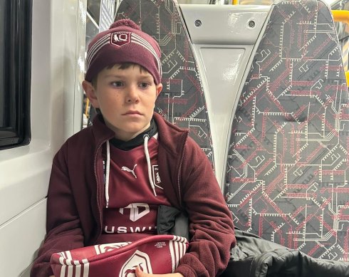 A devastated 11-year-old Carter McPherson on the train home from Suncorp Stadium.