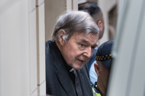 George Pell is led into the Victorian Supreme Court. 
