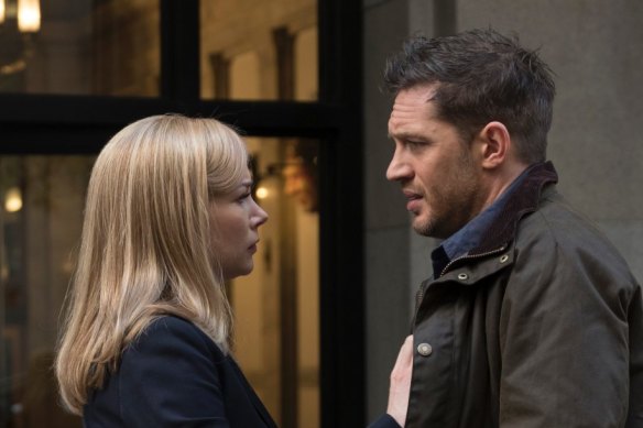 This image released by Sony Pictures shows Michelle Williams, left, and Tom Hardy in a scene from "Venom." (Frank Masi/Sony Pictures via AP)