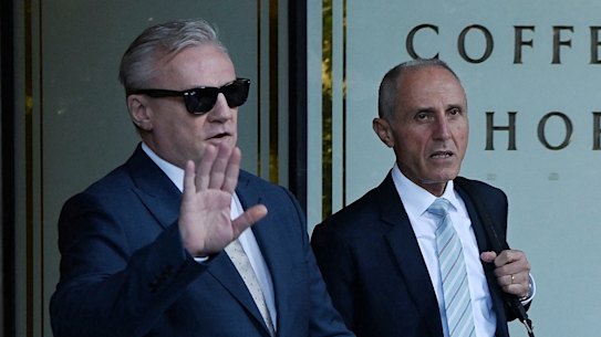 Paul Kent leaves the Downing Centre in sunglasses on Tuesday alongside his lawyer, George Elias.