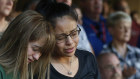 Students Celeste Lujan, left, and Yasmin Natera mourn the loss of a friend in the latest mass shooting, at the weekend.
