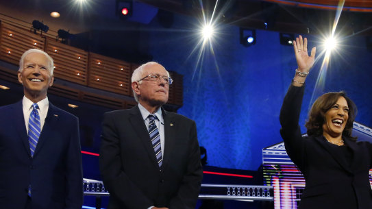 Democratic presidential candidates former vice president Joe Biden, left, Senator Bernie Sanders and Senator Kamala Harris on stage,