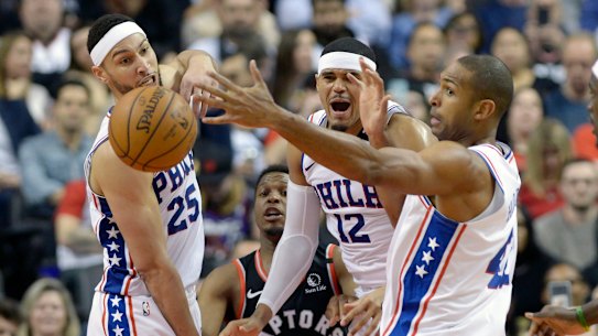 Ben Simmons, Toronto's Kyle Lowry, Tobias Harris and Al Horford battle for a loose ball.