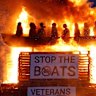Effigies of migrants in a boat burn atop the bonfire at Moygashel, Northern Ireland.