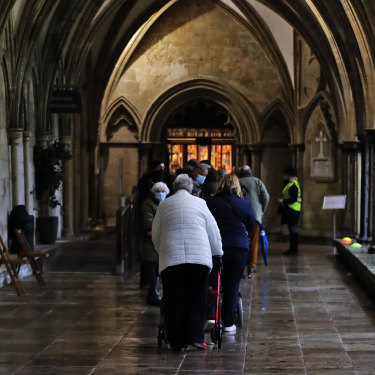 People queue for the vaccine in the cathedral’s 13th century cloisters. 