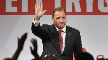Prime minister and party leader of the Social Democrat party Stefan Löfven waves at an election party in Stockholm, on Sunday.