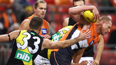 Jacobs tries to escape the Richmond defence.