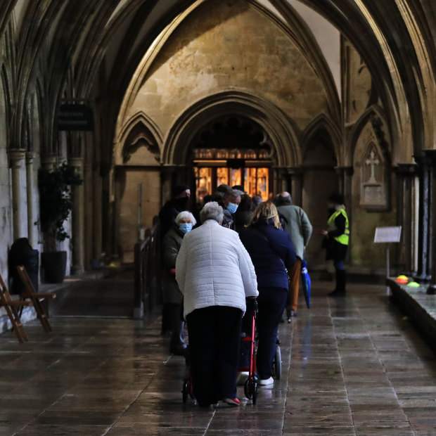 People queue for the vaccine in the cathedral’s 13th century cloisters. 