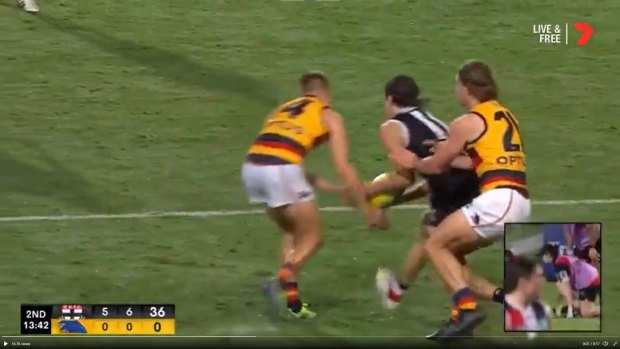 Adelaide’s David Mackay and St Kilda’s Hunter Clark simultaneously lunge for the ball. Clark ended up with a broken jaw.