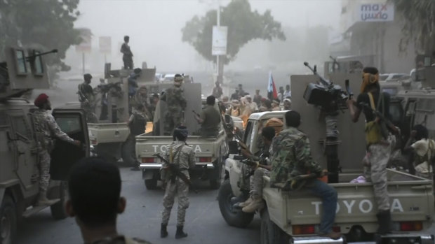 Southern Transitional Council separatist fighters line up to storm the presidential palace in the southern port city of Aden, Yemen, on Friday.
