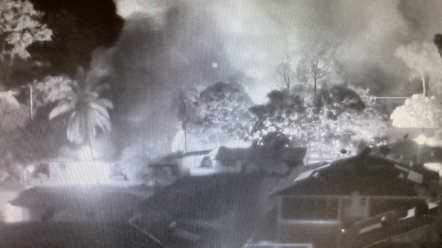 CCTV footage shows smoke from burning homes in Aurukun during unrest on New Year's Day.