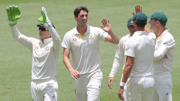 Fine margins: Pat Cummins (second left) is congratulated after dismissing Virat Kohli with controversial catch by Peter Handscomb.