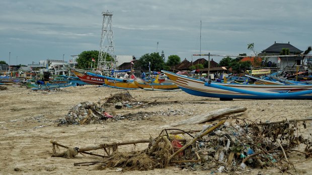 Plastic trash piled up among the fishing boats waiting for pick up at Kedonganan Beach in Bali. 