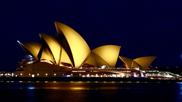 The Sydney Opera House , illuminated in gold for children's cancer research.