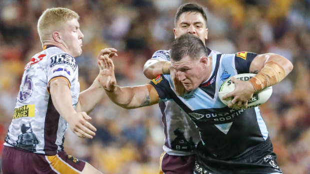 One who can hold his head high: Cronulla captain Paul Gallen drives forward against the Broncos.