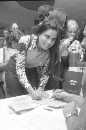 Annette Finkel, 19, fills in the enrolment form, aided by Mark Plummer, one of five students who staffed the table set up in the Union building.