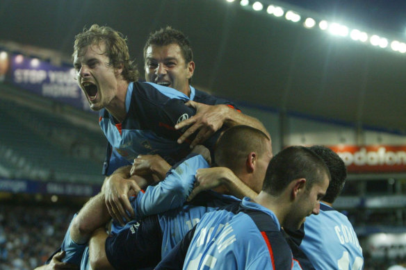 Sydney FC players celebrate after a Dwight Yorke goal in the first half of the Hyundai A-League opening game against Melbourne Victory at Aussie Stadium, Sydney, on August 28, 2005.