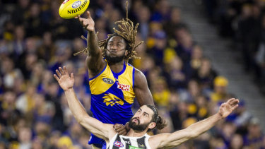 Eagle Nic Naitanui soars over Brodie Grundy at Optus Stadium but Collingwood became the second team this year to knock off the Eagles at home.