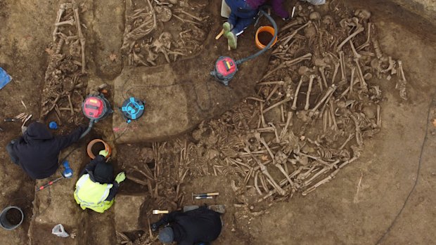 People work on the excavation of a Roman mass grave from the end of the 1st century AD, in the Simmering district of Vienna, Austria.