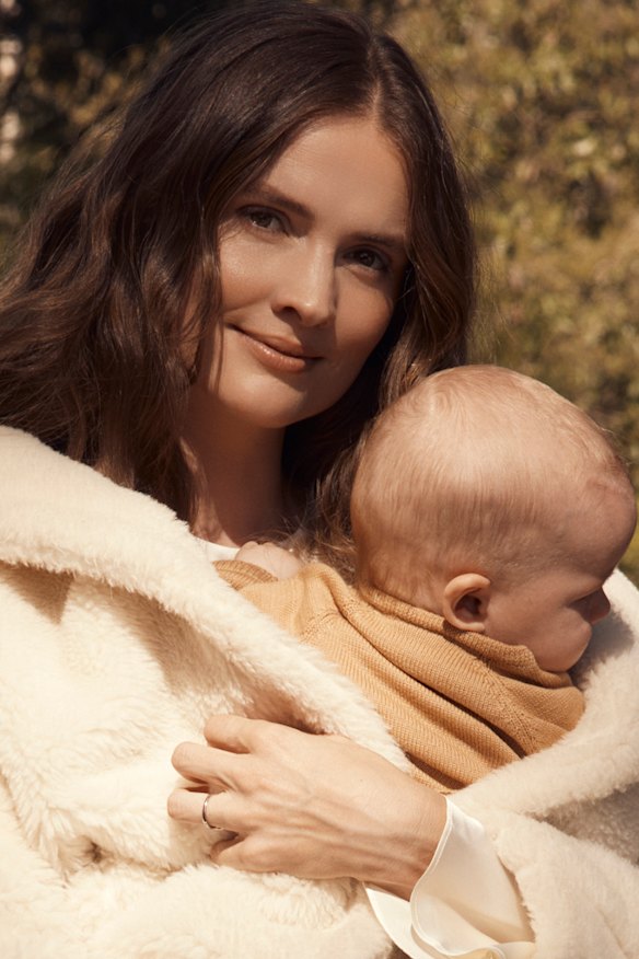 Laura Henshaw, with baby Atlas. Laura wears Max Mara coat. Zara dress and boots. Atlas wears Nature Baby (throughout).