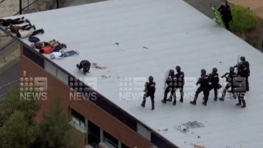 Officers storming the Banksia Hill Detention Centre rooftop on Wednesday.
