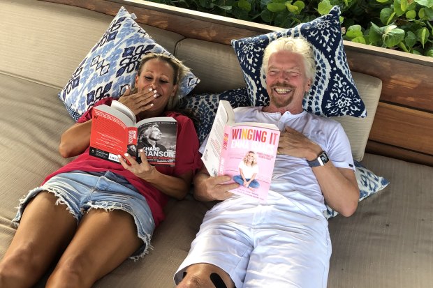 Isaacs and her mentor, British billionaire Richard Branson, enjoy each other’s book while in the Caribbean.