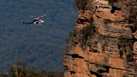 A police air rescue helicopter removes the bodies on Tuesday morning.