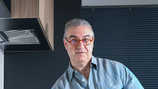 Mint Kitchens owner Frank Iaria leaning against an engineered stone bench in his Moonee Ponds showroom.