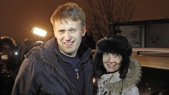ussian opposition leader Alexei Navalny, left, and his wife Yulia are surrounded by journalists after he is released from police custody on the outskirts of Moscow early Wednesday, December. 21, 2011.