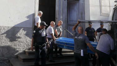 Police remove the body of a shooting victim from the Metropolitan Cathedral in Campinas.