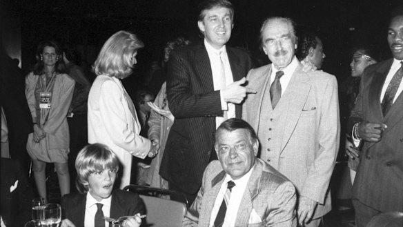 Donald Trump points to his father, Fred Trump at Trump Plaza Hotel, when Donald Trump jnr (front left) was still a child.