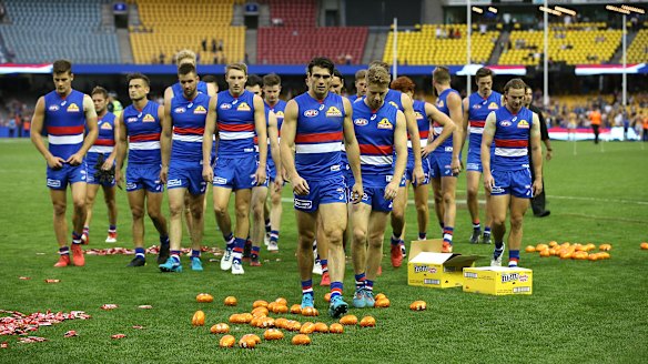No chocolates: Defeated Dogs walk off Ethiad Stadium after a heavy round two loss to West Coast on Easter Sunday.