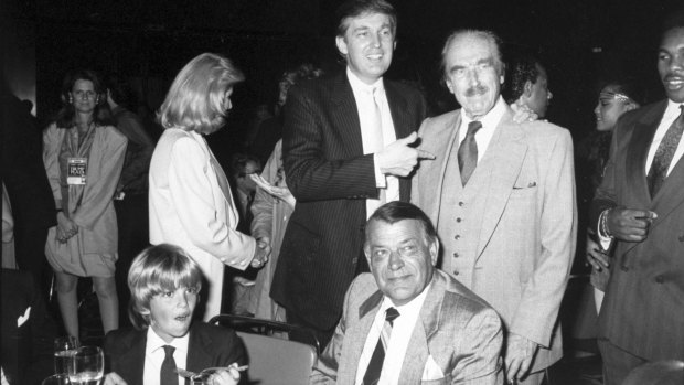 Donald Trump points to his father, Fred Trump at Trump Plaza Hotel, when Donald Trump jnr (front left) was still a child.