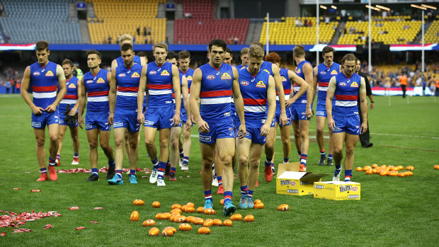 No chocolates: Defeated Dogs walk off Ethiad Stadium after a heavy round two loss to West Coast on Easter Sunday.