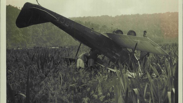 Menzies meets with a mishap on landing after completing the first solo flight across the Tasman Sea. The Aeroplane with her nose buried in the swamp.  