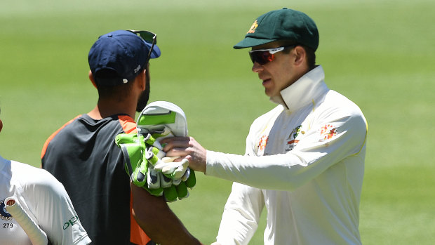 Polite: After their earlier clashes, Tim Paine and Virat Kohli shake hands.