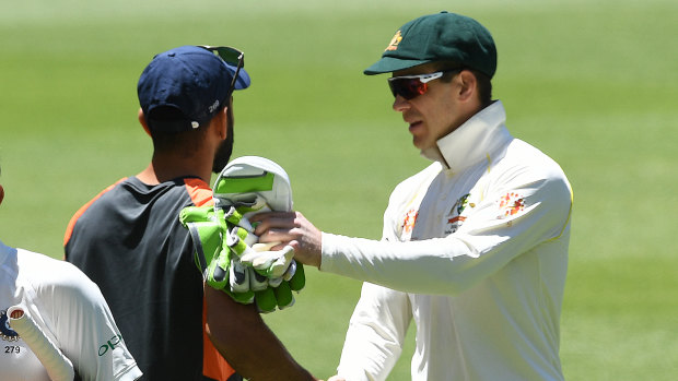 Tim Paine and Virat Kohli shake hands after the match.