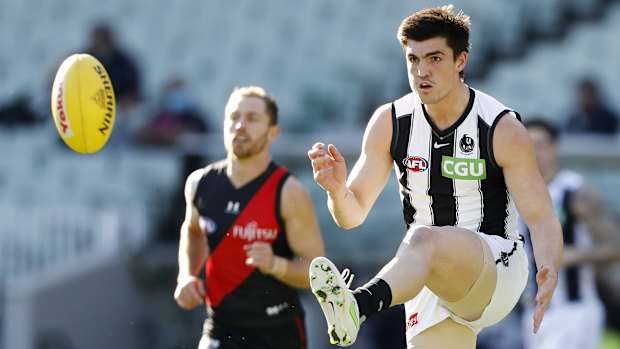 Brayden Maynard of the Magpies kicks the ball at the MCG. 