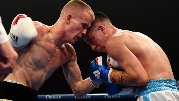 Super featherweight star: Liam Wilson (left) lands a blow against Mauro Perouene.