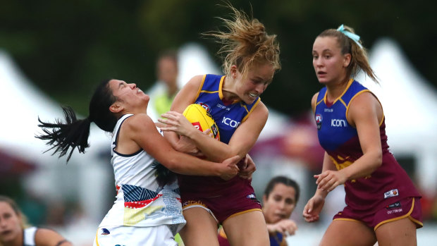 Isabel Dawes of the Lions is tackled by Rachelle Martin of the Crows.