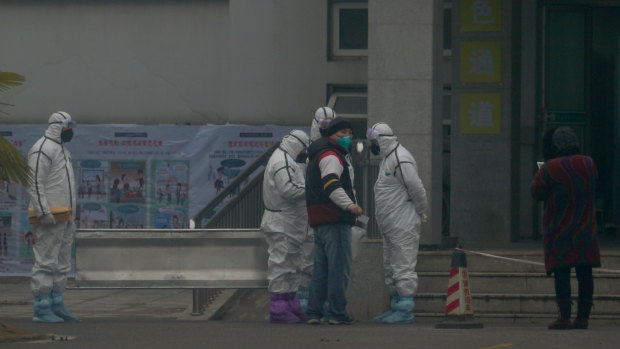 Staff in biohazard suits outside a hospital in Wuhan.